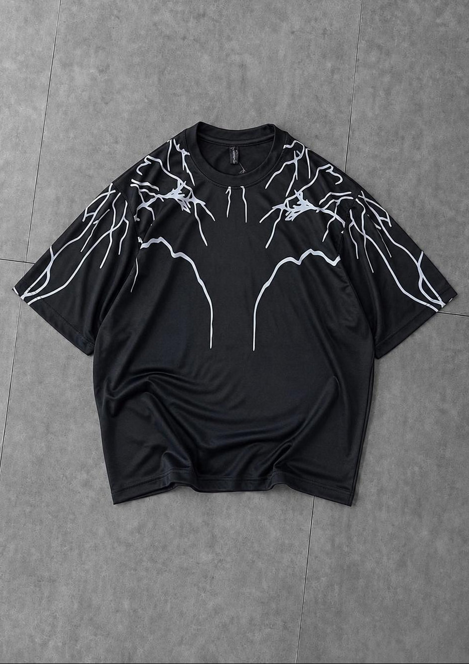 Black oversized t-shirt with bold lightning graphic print for streetwear style